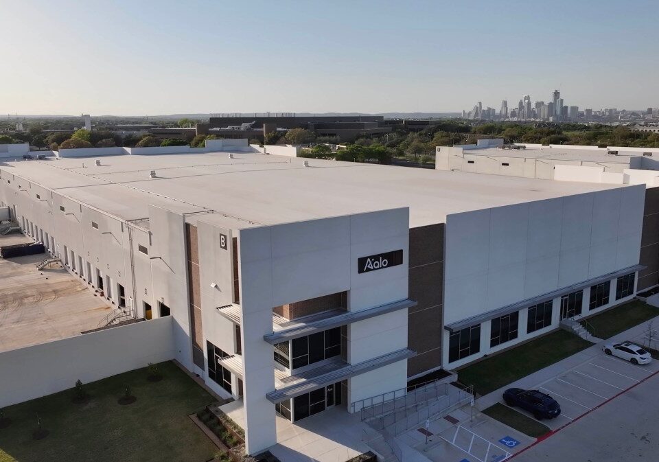 Aalo Atomics factory seen from the air with Austin's skyline in the background.