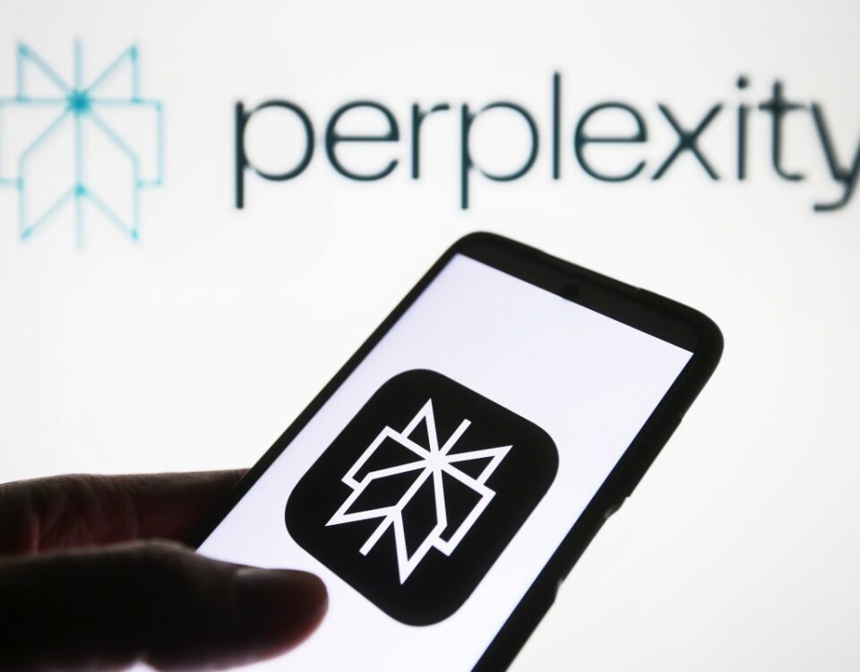Perplexity AI logo is seen on a smartphone and on a PC screen.
