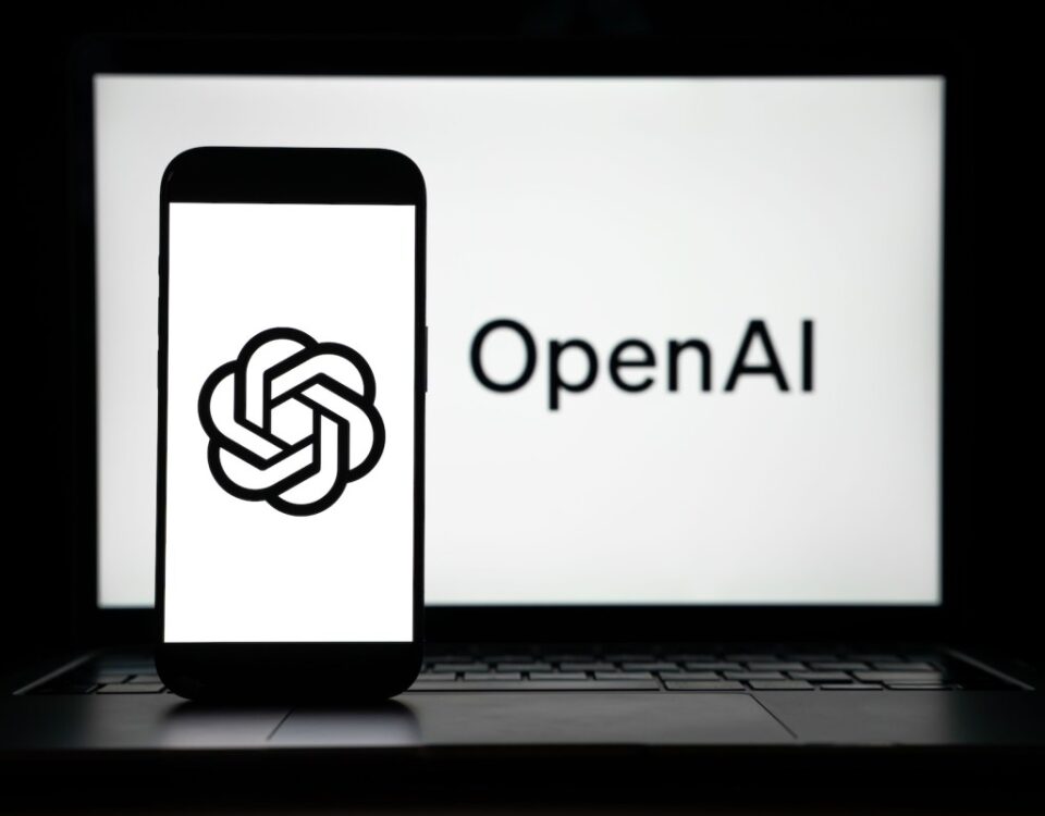 the logos of Open AI displayed on both computer and smart phone screen
