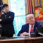 Tesla CEO Elon Musk and U.S. President Donald Trump listen to a question from reporters in the Oval Office of the White House.
