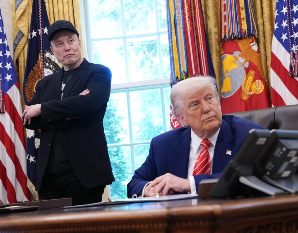 Tesla CEO Elon Musk and U.S. President Donald Trump listen to a question from reporters in the Oval Office of the White House.