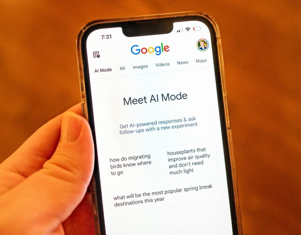 A person holding an iPhone and using Google AI Mode
