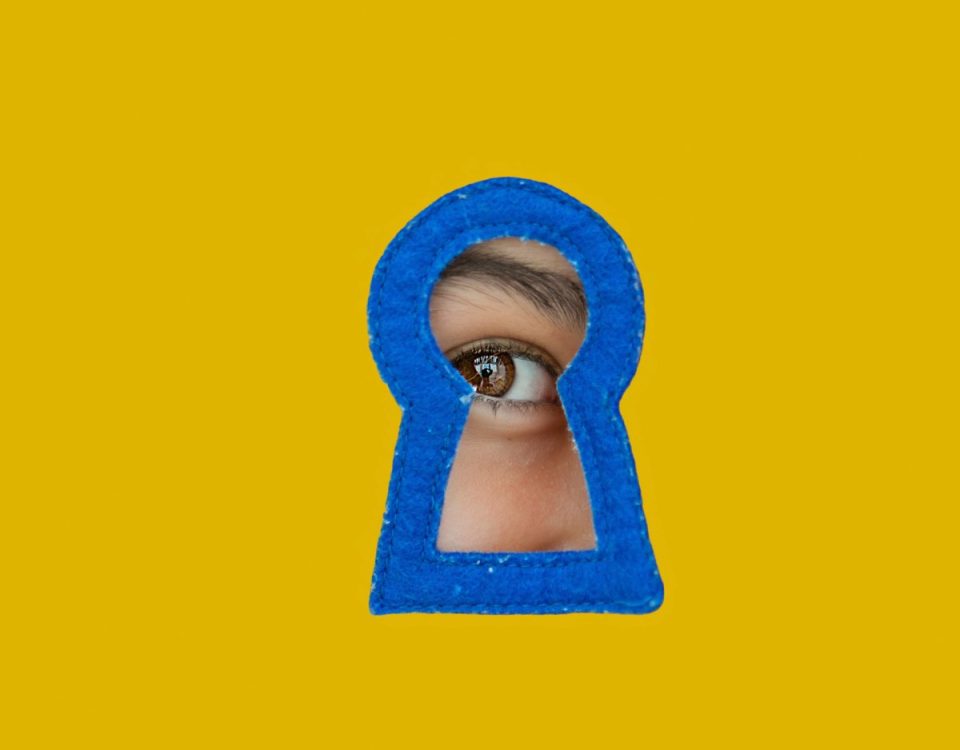 a child looking through a blue keyhole