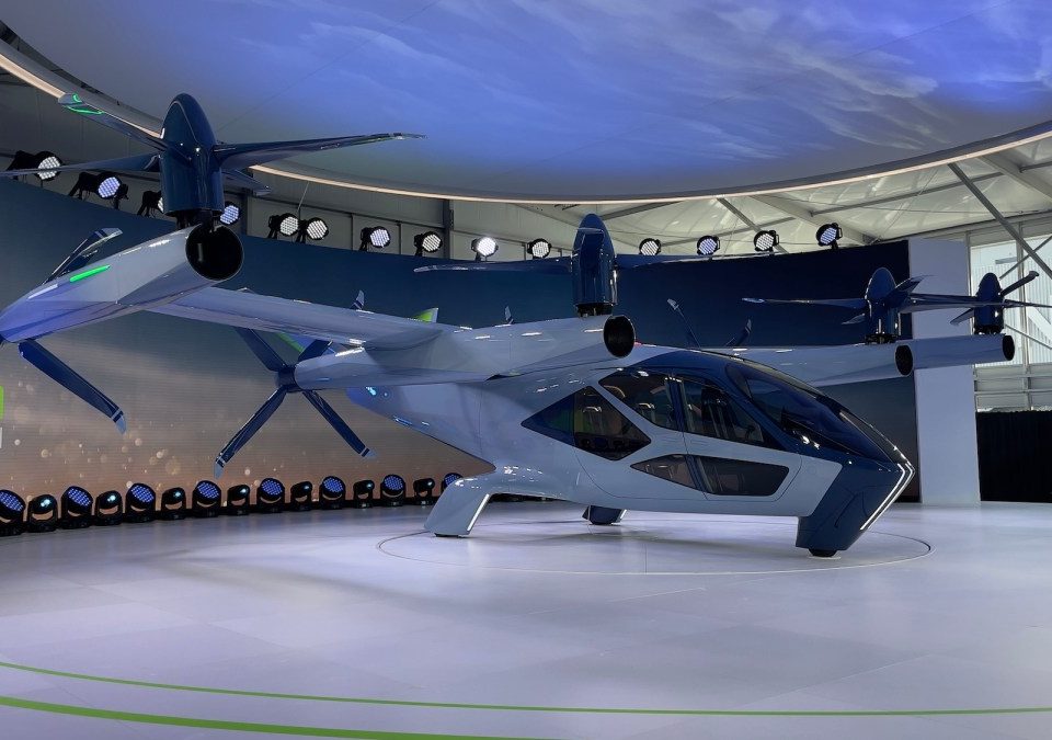 an electric air taxi paint in white sits on a platform at CES 2024