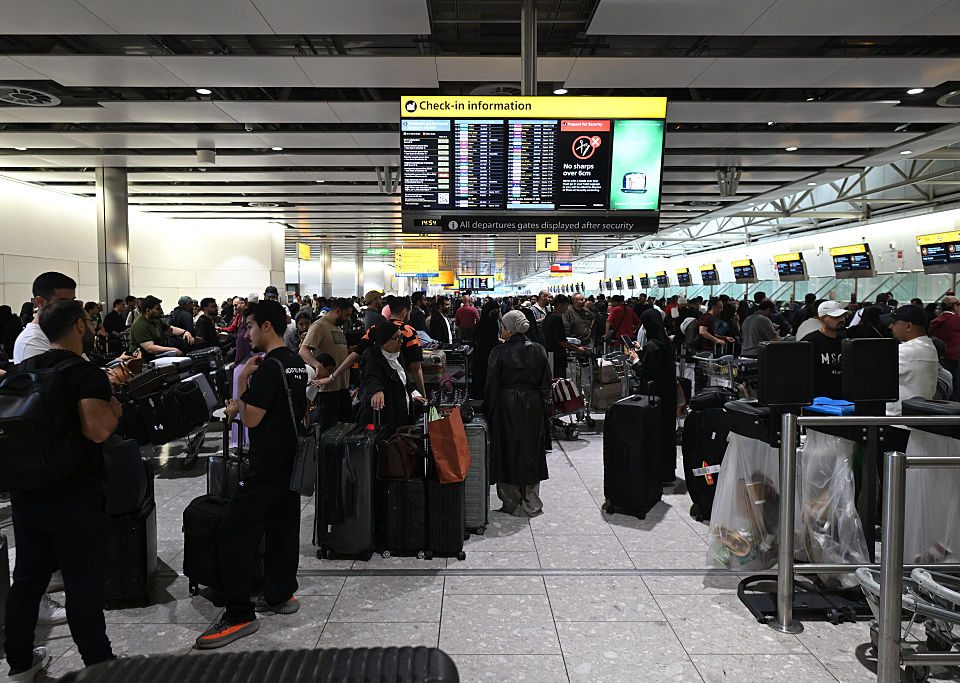 Travellers wait in terminal 4 at Heathrow Airport, west of London on September 20, 2025. Major European airports including Brussels, Berlin and London's Heathrow were Saturday hit by "cyber-related disruption" affecting check-in and baggage drop systems and causing delays, airport service provider Collins Aerospace told AFP.