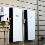 Two Tesla Powerwalls sit on the outside of a house.