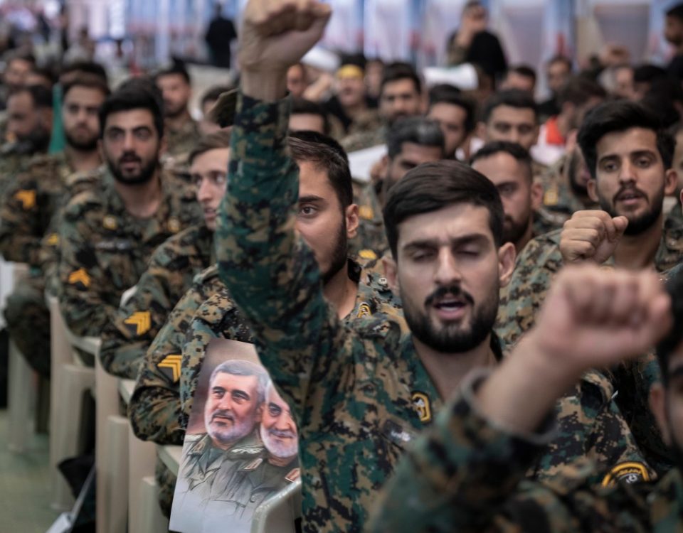 Military members of the Iranian police special forces shout anti-U.S. and anti-Israeli slogans as one of them holds a poster featuring portraits of the former commander of the Islamic Revolutionary Guard Corps Quds Force, Major General Qassem Soleimani, who is killed in a U.S. strike in Baghdad, and Brigadier-General Amir Ali Hajizadeh, former Commander of the IRGC - Aerospace Force, during a ceremony at the Imam Khomeini Grand Mosque in Tehran, Iran, on August 7, 2025, to commemorate the civilians and Islamic Revolutionary Guard Corps (IRGC) generals killed during the 12-day war between Iran and Israel.