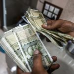 An employee counts 500 rupee banknotes at a currency exchange in New Delhi, India, on Saturday, Aug. 30, 2025. The Indian rupee slumped to a record low versus the dollar on concern that 50% US tariffs will hurt the country's economic growth and corporate earnings.