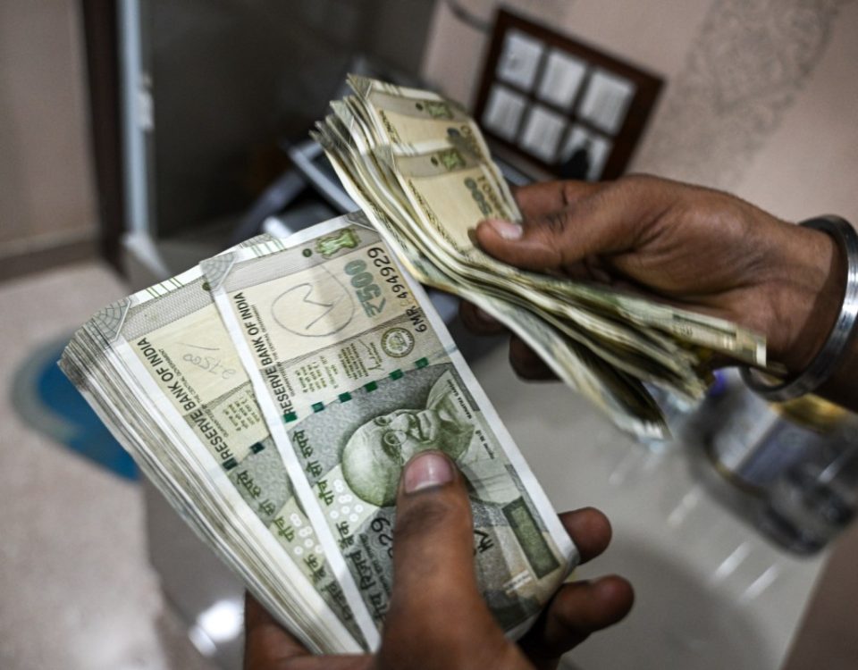 An employee counts 500 rupee banknotes at a currency exchange in New Delhi, India, on Saturday, Aug. 30, 2025. The Indian rupee slumped to a record low versus the dollar on concern that 50% US tariffs will hurt the country's economic growth and corporate earnings.