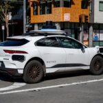 Waymo self driving car waiting at a city intersection in San Francisco