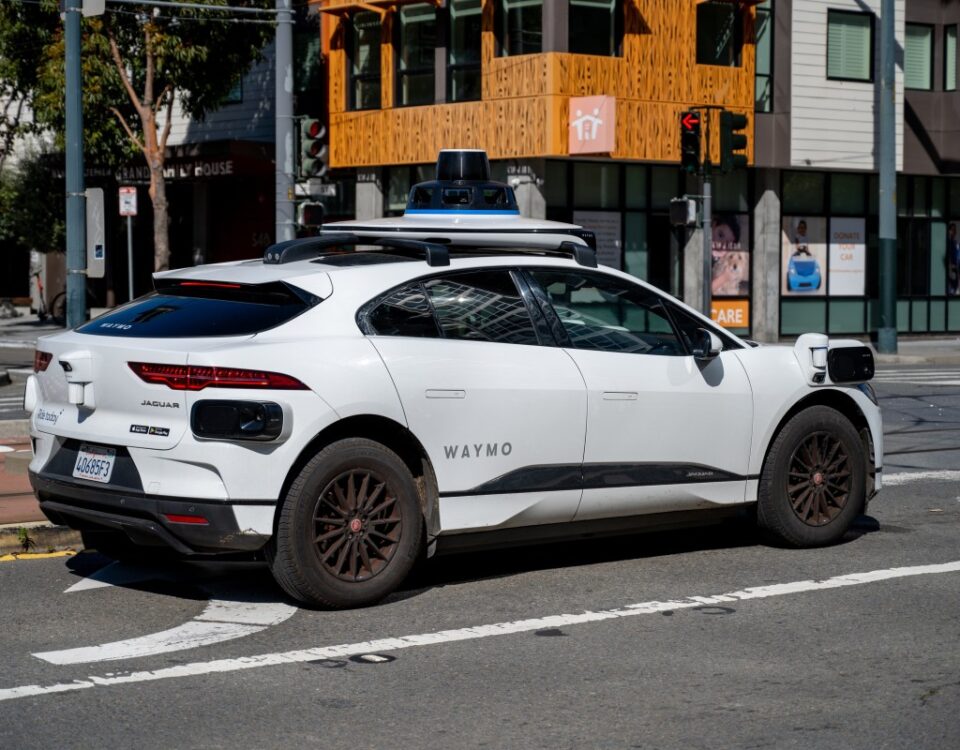 Waymo self driving car waiting at a city intersection in San Francisco