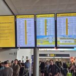 This photograph shows passengers waiting next to a flight information board of the Brussels Airport in Brussels on September 20, 2025, after the airport's system was hit by a "cyberattack" overnight on September 19.