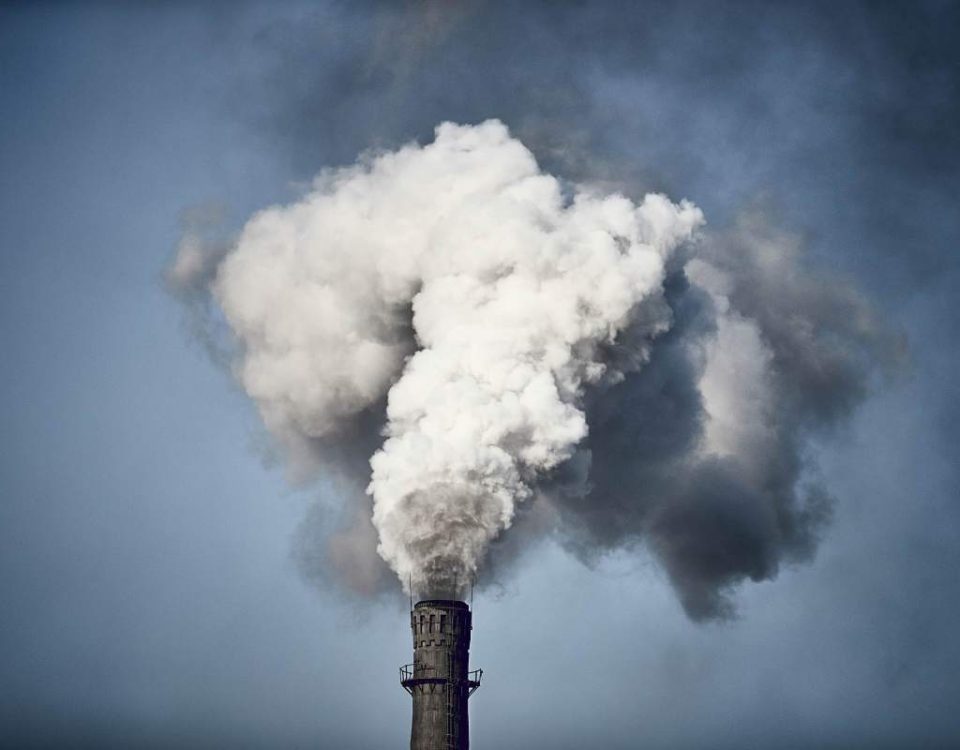 Thick smoke billowing out of the chimney of a Chinese factory.