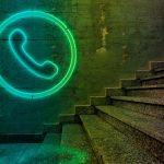 Telephone sign on concrete wall.