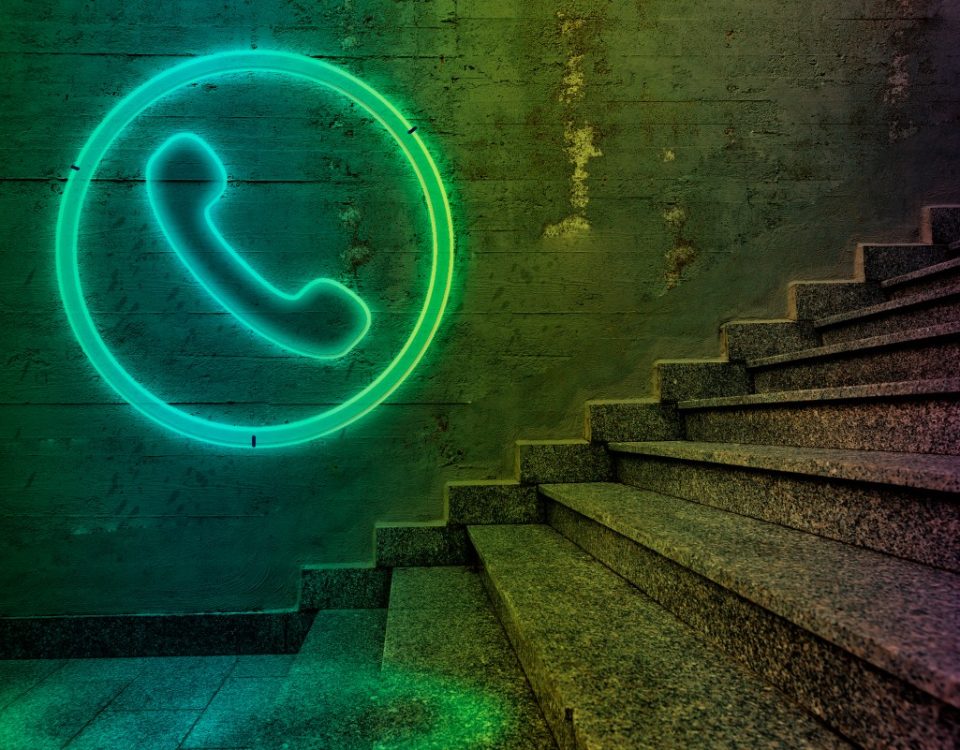Telephone sign on concrete wall.