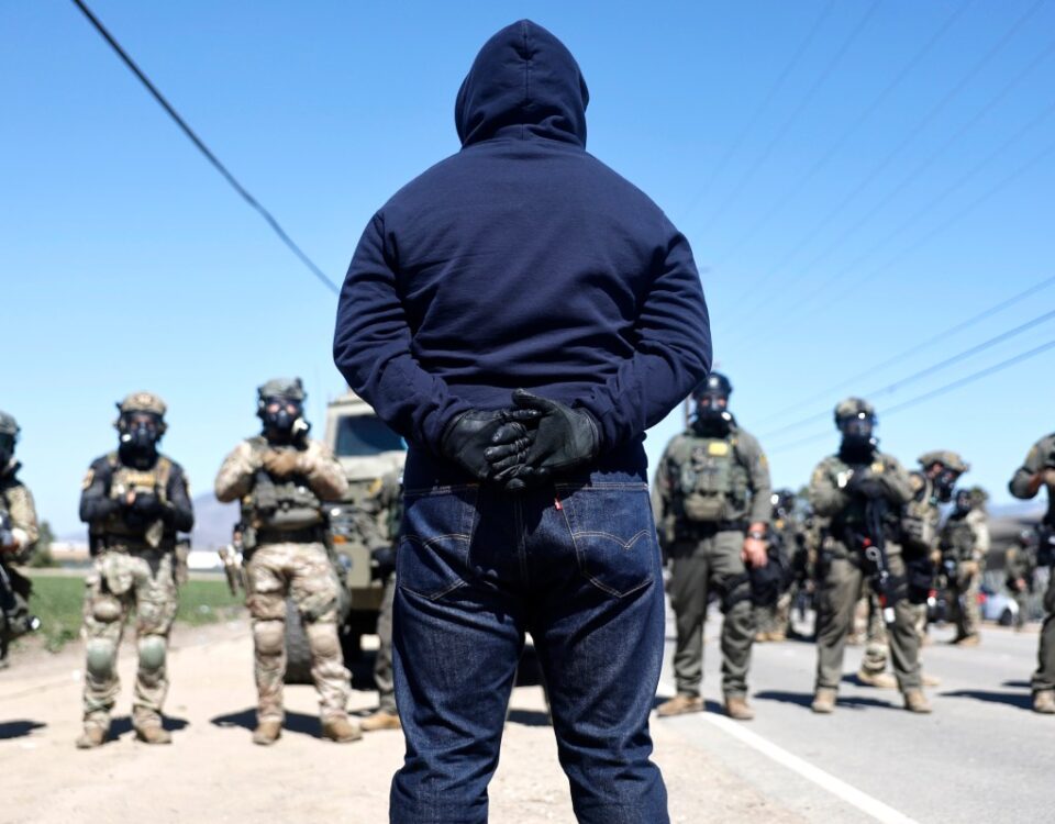 Federal agents block people protesting an ICE immigration raid at a nearby licensed cannabis farm on July 10, 2025 near Camarillo, California.