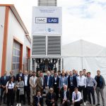 The DACLab team stands in front of one of their direct air capture units.