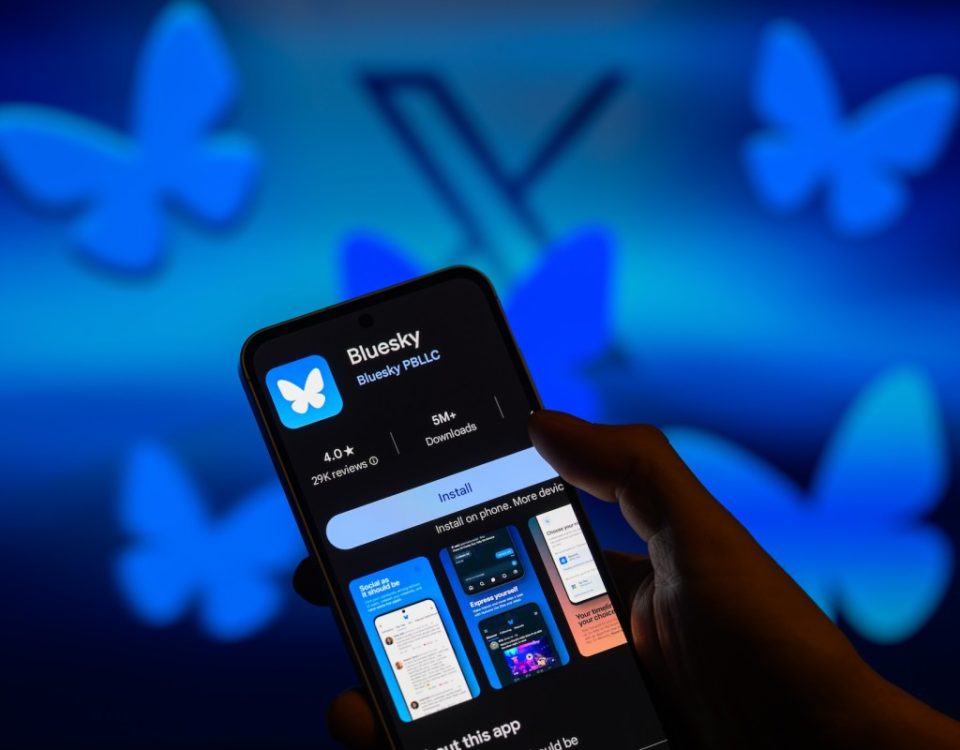 The Bluesky app logo is displayed on a smartphone
