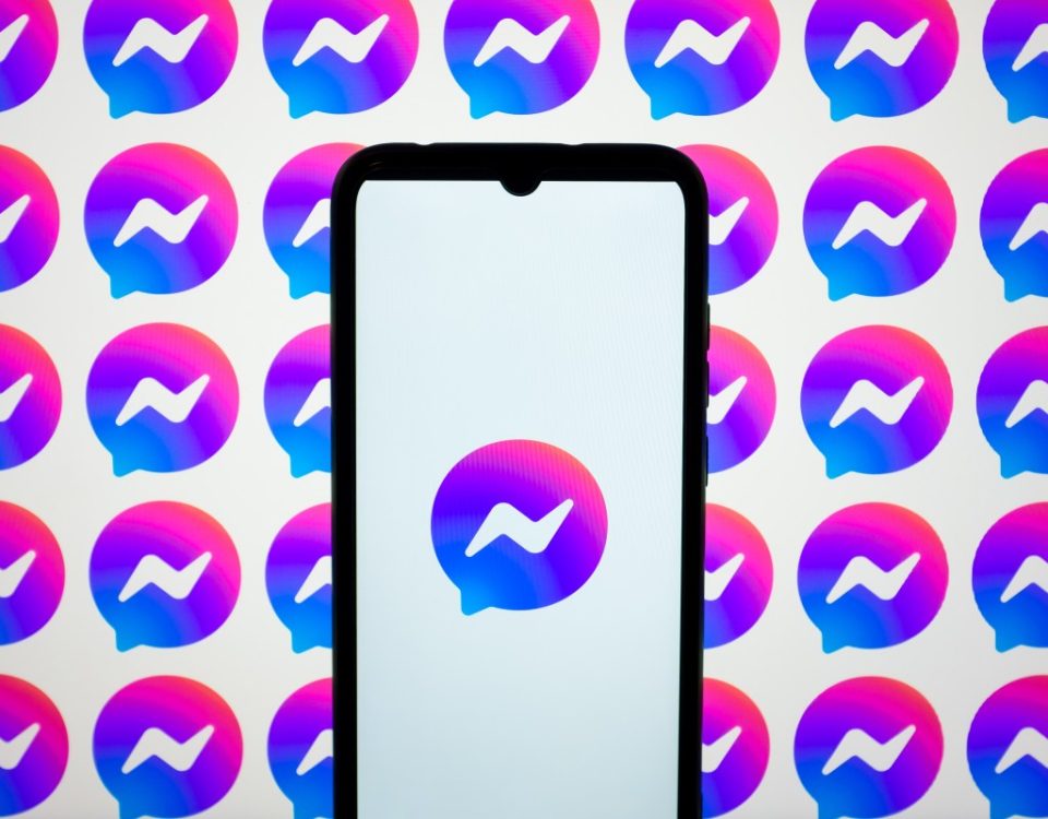 In this photo illustration, Messenger logos are displayed on a smartphone screen and on a computer screen.