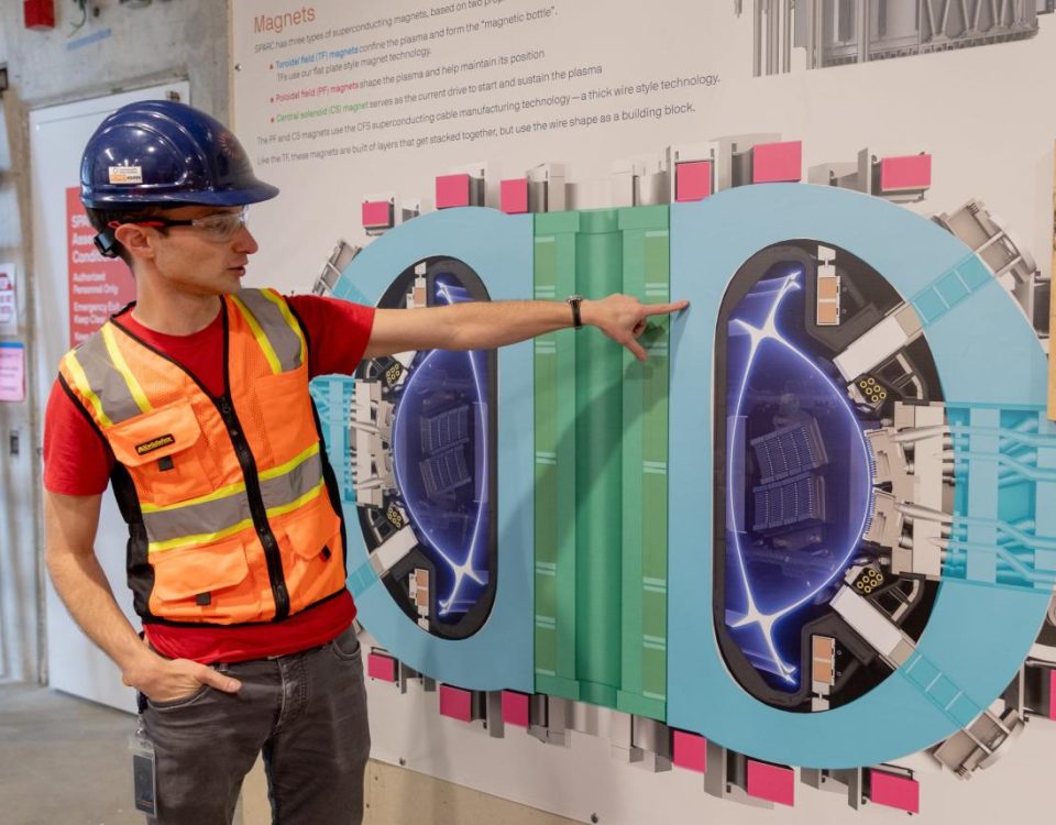 Alex Creely, director of Tokamak operations at Commonwealth Fusion Systems, points to a reactor schematic.