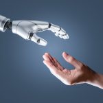 image of a humanoid hand reaching out to a human hand