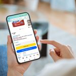 A person holding phone with Amazon app open