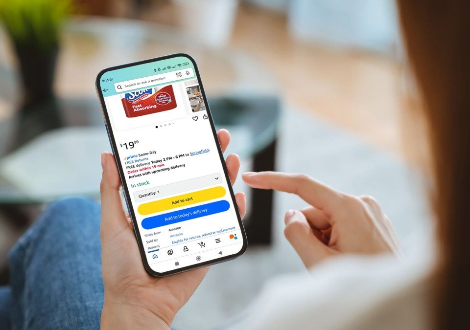 A person holding phone with Amazon app open