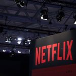 A Netflix Inc. logo sits on the online television streaming company's exhibition area at the Gamescom gaming industry event in Cologne, Germany