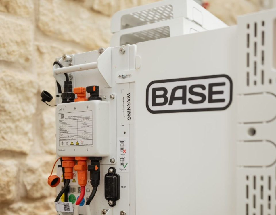 A Base Power battery sits next to a home.