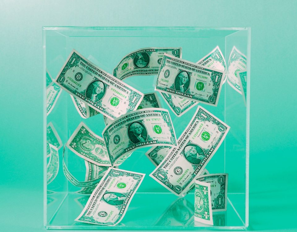 Dollar bills floating in a box