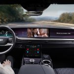 The interior of the upcoming Cadillac Escalade shows a driver watching a movie as the automated system handles the driving.