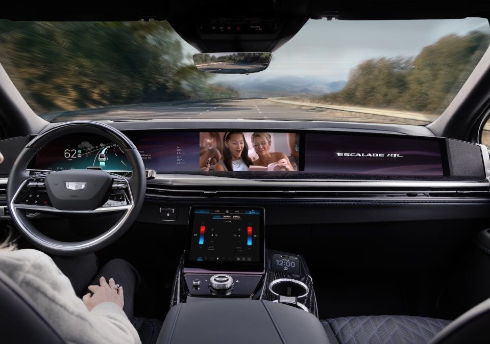 The interior of the upcoming Cadillac Escalade shows a driver watching a movie as the automated system handles the driving.