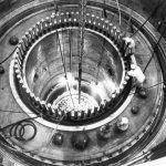 Engineers look inside a nuclear reactor.