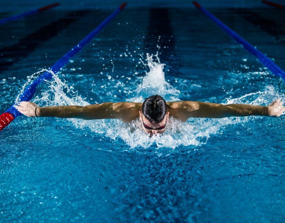 man swimming the butterfly stroke