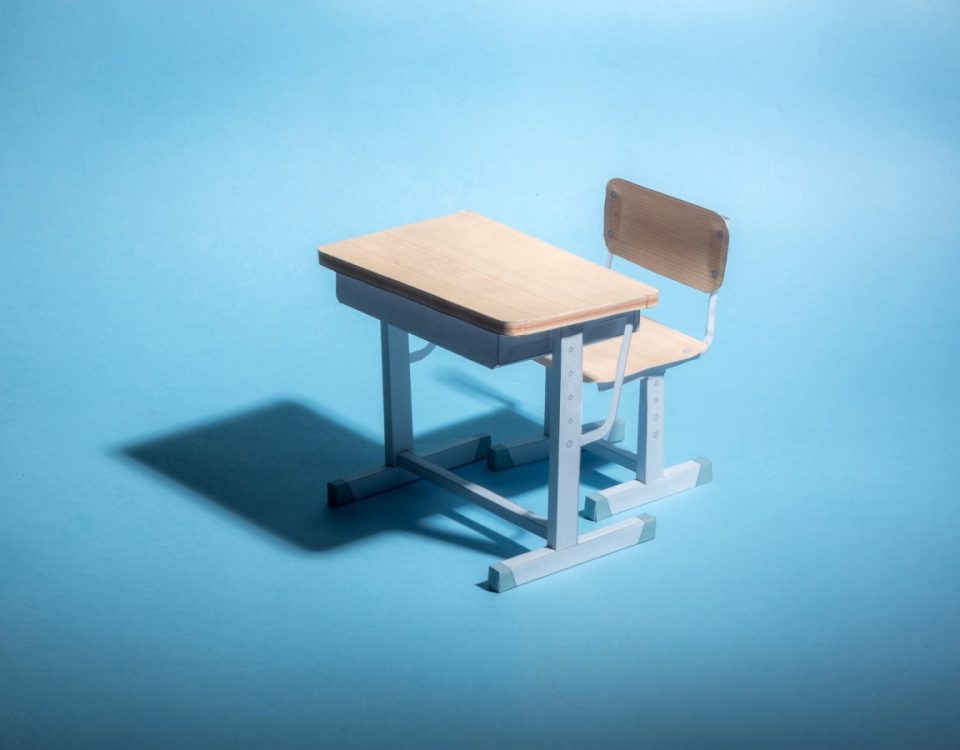 Empty school desk on a blue background. .