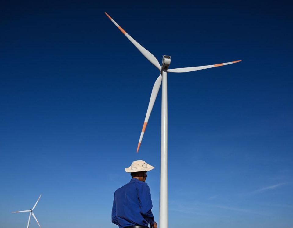 A man in front of a wind turbine in Vietnam